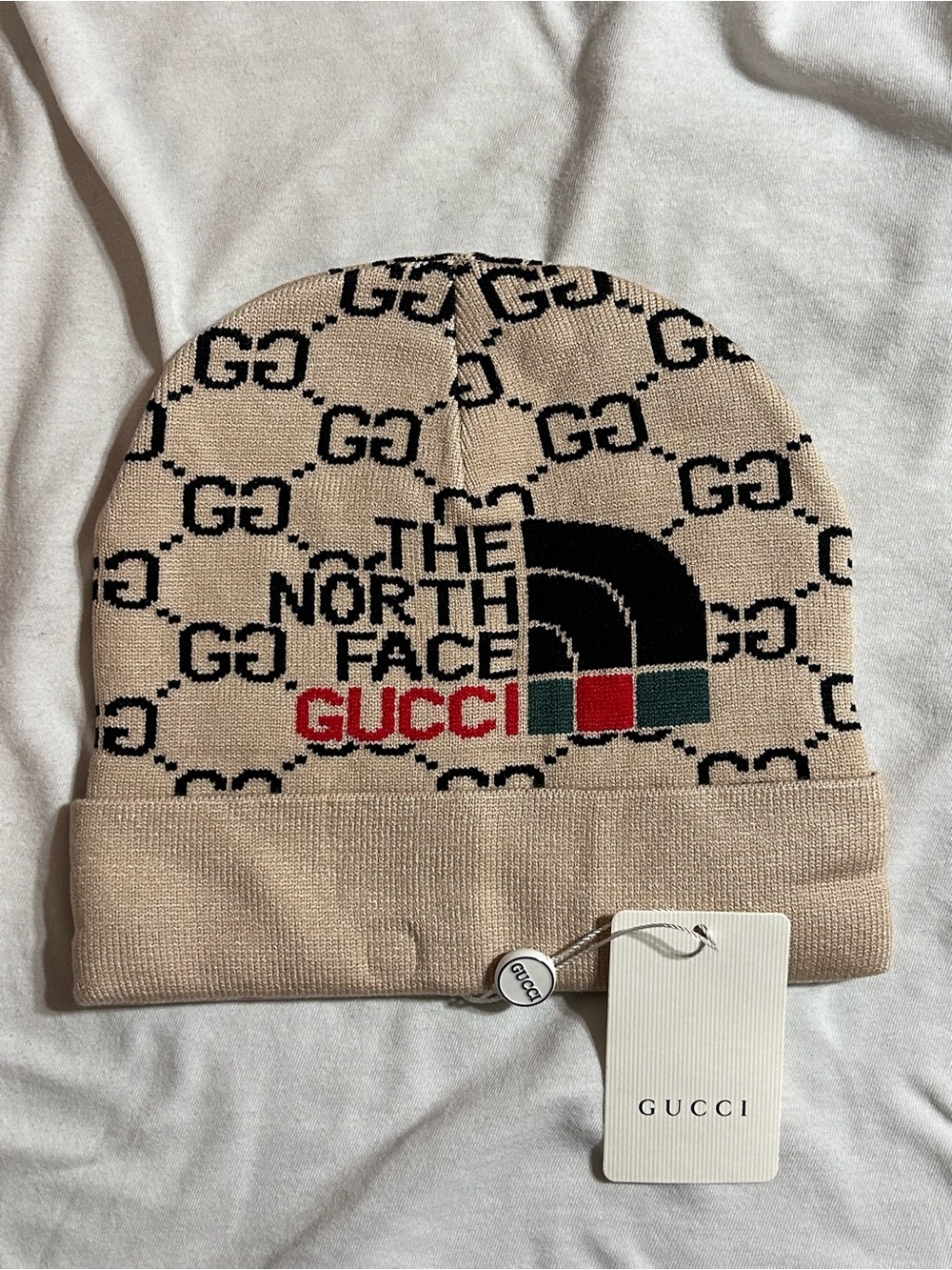 Beige Black Logo The North Face Beanie with Red and Green Accents